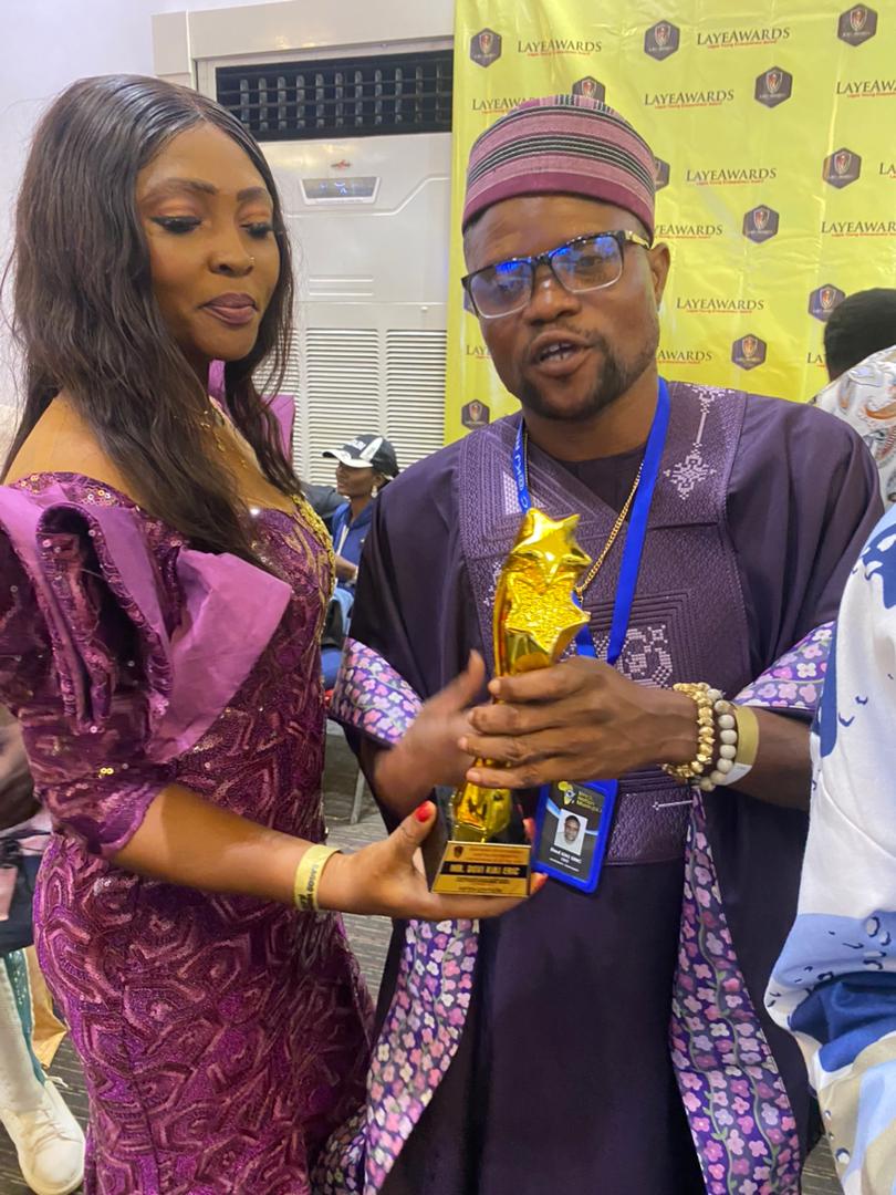 kiki eric dovi on laye award night as his wife present him his award