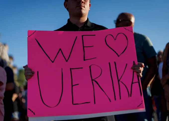 A man holds a sign in support of Erika Kirk, at a memorial for Charlie Kirk at the Turning Point USA headquarters in Phoenix, Arizona, on September 12 Eric Thayer/Getty Images