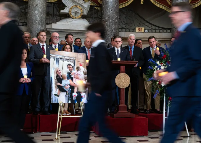A poster featuring Erika and Charlie Kirk and their two children is displayed during a memorial service in the US Capitol's Statuary Hall on September 15. Tom Williams/CQ-Roll Call, Inc./Getty Images